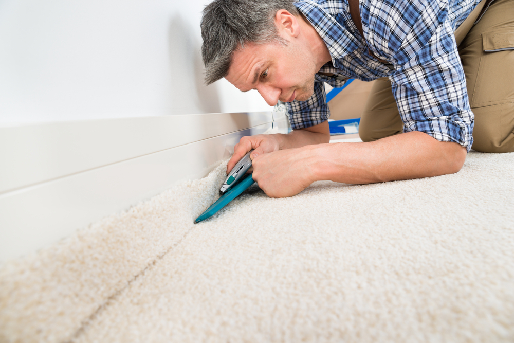 Professional installing carpet