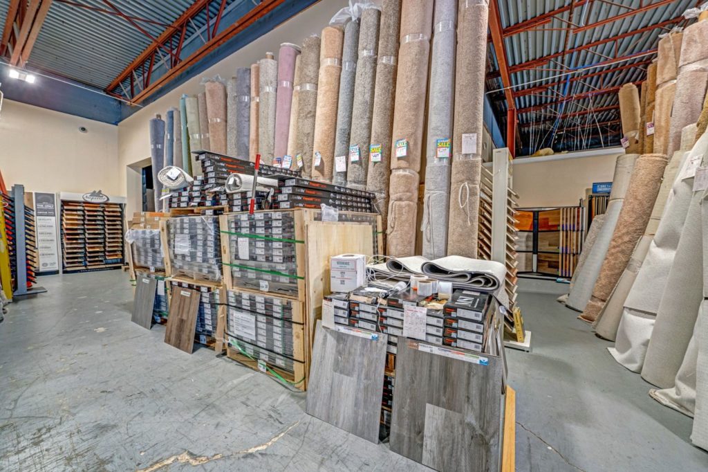 Showroom with carpet rolls going up to the ceiling